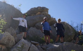 Kerans, Sitgreaves, and Ben Smith study massive rudist-bearing carbonates of the Devils River trend near Moose Canyon.