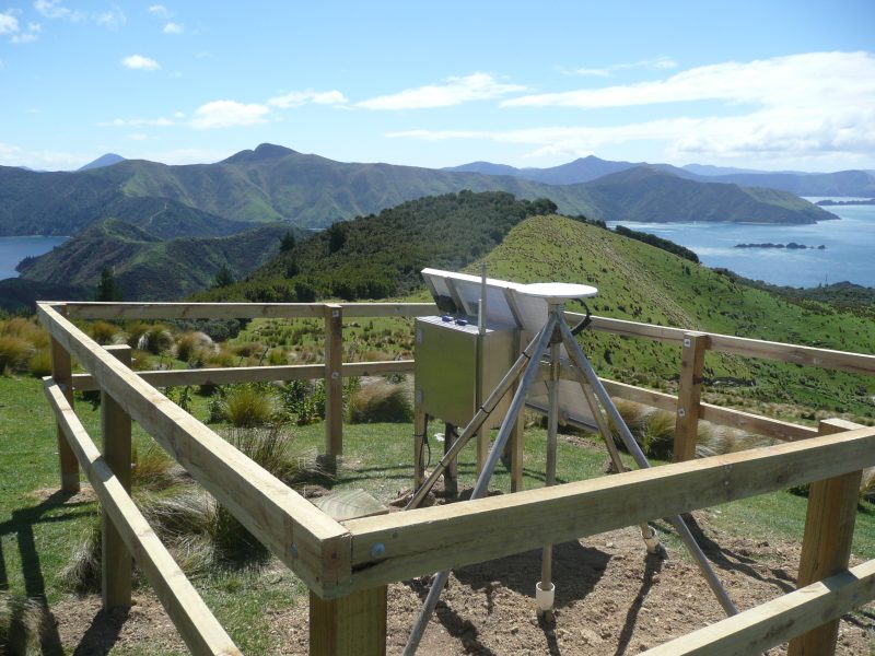 A GPS station overlooking mountains and water