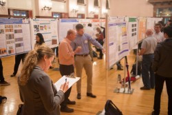 Research symposium judge Mel Bechberger, a geologist at ConocoPhillips, makes notes among the presentations.