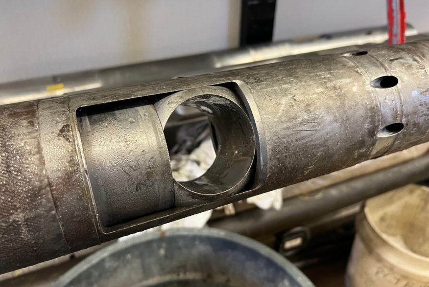 The PCTB is a tube like metal object. The ball valve in the center of the photo is hollow and has turned so that the 'closed' size is sealing what's inside. The tool looks dirty, wet and used.