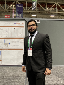 Afzal Shadab posing in front of a science poster
