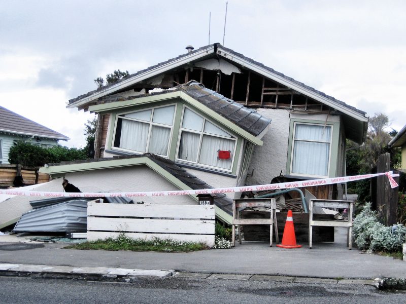 The front of the house has almost entirely collapsed. The property is sealed off with hazard tape.