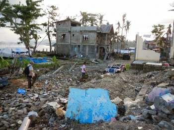 Typhoon Haiyan was the strongest hurricane ever recorded to make landfall. Working with villagers, the researchers sampled wells among the debris and destruction. Professor Phil Bennett is walking over the ruins of a concrete house. Image: Bayani Cardenas