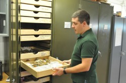 Joshua Lively with mosasaur fossils.