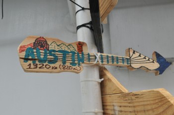 A sign made by Gulick indicating the way to Austin, Texas from the L/B Merida. It joins other signs made by other research scientists on the Myrtle. 