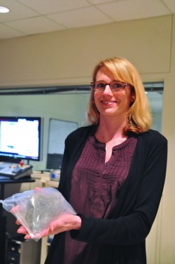 Ph.D. Student Romy Hanna with a rock sample in the CT lab.