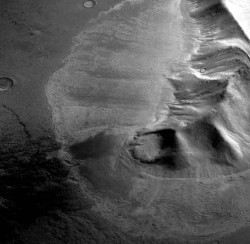 Perspective view of a mountain in the eastern Hellas region of Mars surrounded by a lobate deposit with flow textures on the surface. Recent measurements from the Mars Reconnaissance Orbiter SHARAD radar sounder have detected large amounts of water ice in similar deposits, arguing for the flow of glacial-like structures on Mars in the relatively recent geologic past. This suggests that snow and ice accumulated on the slope face and flowed viscously over the neighboring plains and is now protected from sublimation by a layer of rock debris and dust. Image is 31 km (20 miles) across. Topographic data shown here was acquired by the High Resolution Stereo Camera (HRSC) on the Mars Express spacecraft and is courtesy of ESA/DLR/FU Berlin.