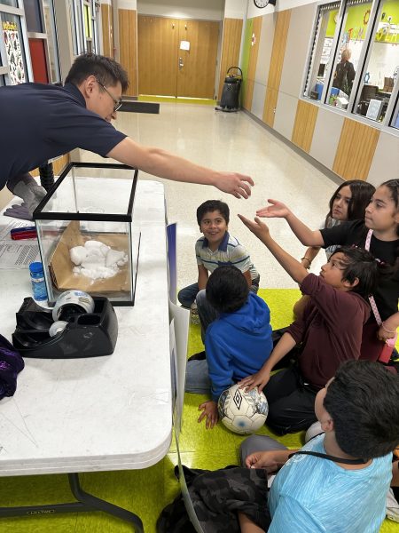 Postdoctoral fellow Zhicheng “William” Wang teaches students about carbon dioxide. 