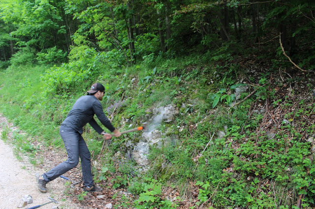 Graduate student Nick Ettiger taking samples with a sledgehammer.