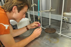 Jackson school undergraduate Esben Pedersen sampling dissolved gases.