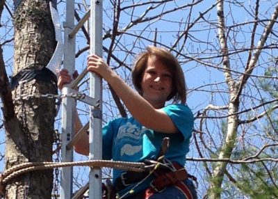 Ashley Matheney climbing a tree.