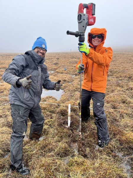Close up photo of the two in a field, Neelarun is giving a thumbs up.