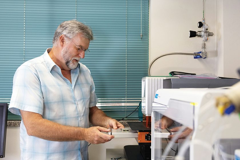 Research scientist Nate Miller loads a sample into his lab’s old laser ablation system.