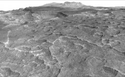 This vertically exaggerated view shows scalloped depressions in a part of Mars where such textures prompted researchers to check for buried ice, using ground-penetrating radar aboard NASA's Mars Reconnaissance Orbiter. They found about as much frozen water as the volume of Lake Superior. NASA/JPL-Caltech/University of Arizona