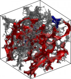 This image shows the displacement of oil by brine in the rock salt’s pore space (transparent gray). The oil is represented by the blue and red color, and water occupies the pore space where there is no visible oil. Image by the Cockrell School of Engineering.