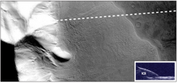 Portion of a large rock-covered flow feature in the eastern Hellas region of Mars. Recent measurements from the Mars Reconnaissance Orbiter SHARAD radar sounder have detected large amounts of water ice in this deposit, arguing for the flow of glacial-like structures on Mars in the relatively recent geologic past. This suggests that snow and ice accumulated on the slope face and flowed over the neighboring plains and is now protected from sublimation by a layer of rock debris and dust. Dashed line shows path of spacecraft and inset shows resulting radar reflections. Over the glacier, there are two reflections: one from the sloping surface and one from the subsurface below the ice. Image is 20 km (12.8 mi.) by 50 km (32 mi.). From the Context Camera on Mars Reconnaissance Orbiter. NASA/JPL/Malin Space Science Systems