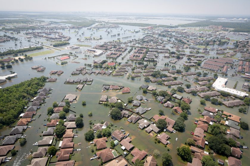 Aerial photo of a flooded neighborhood. The water is upto roof level.