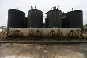 Each day, dozens of trucks hook up to the Gulf Coast-run fracking fluid disposal well site near Gonzales, Texas. Jennifer Whitney