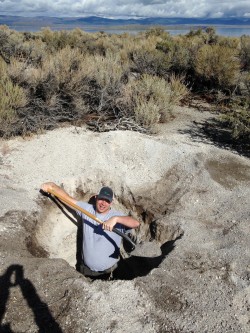 Kenny Befus digs for chips of obsidian in layers of volcanic debris in eastern California.