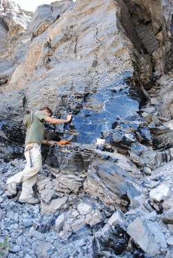 Robert Zinke (B.S. 2012) against a wall of obsidian at Long Valley Caldera in California.