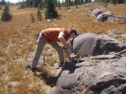  Tim Prather, then an undergraduate, chips stone samples from a lava flow in Yellowstone. He is now a graduate student at the Jackson School. 