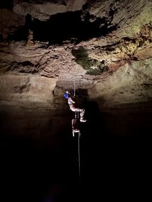 A caver suspended from a rope