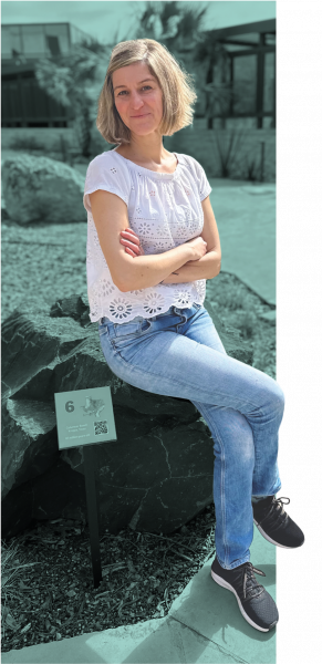 Esti sitting on a rock with colorized background