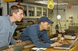 Peter Flemings (right) and Brandon Dugan (left) analyze pore pressure data recovered during an IODP expedition in spring 2005. Pore pressure is a key factor in submarine landslides. Photo by William Crawford.