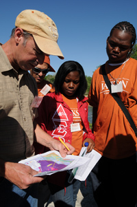 Professor Charles Kerans (left) discusses geologic features near Austin that might make good targets for petroleum exploration.