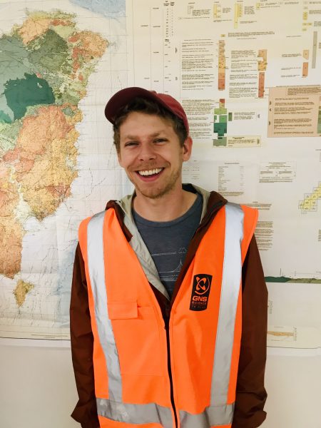 Andrew Gase wearing a high vis jacket and smiling at the camera