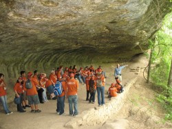 Geologist Chock Woodruff showed students a rock shelter once inhabited by Native Americans.