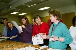 Hilary Olson (right), co-principal investigator for TXESS Revolution, shows teachers how to interpret geologic core samples at the Austin Core Research Center.