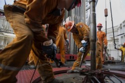Workers prepare drilling pipe on the Petroleos Mexicanos (Pemex) La Muralla IV deep sea crude oil platform in the waters off Veracruz, Mexico. (Susana Gonzalez/Bloomberg)