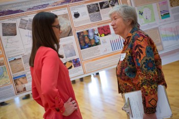 Jackson School Dean Sharon Mosher talks with an attendee of the Student Research Symposium.