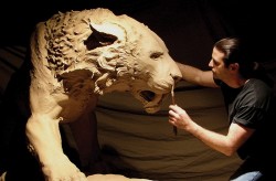 Artist John Maisano sculpting Smilodon from clay. John Maisano.