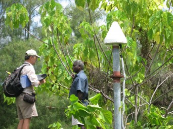 Fred Taylor (left) visits a GPS station in the Solomon Islands