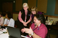 Marsha Willis (left), professional development coordinator for Texas Regional Collaboratives, and Kathy Ellins (center), TXESS Revolution lead principal investigator, discuss geological cores with a teacher.