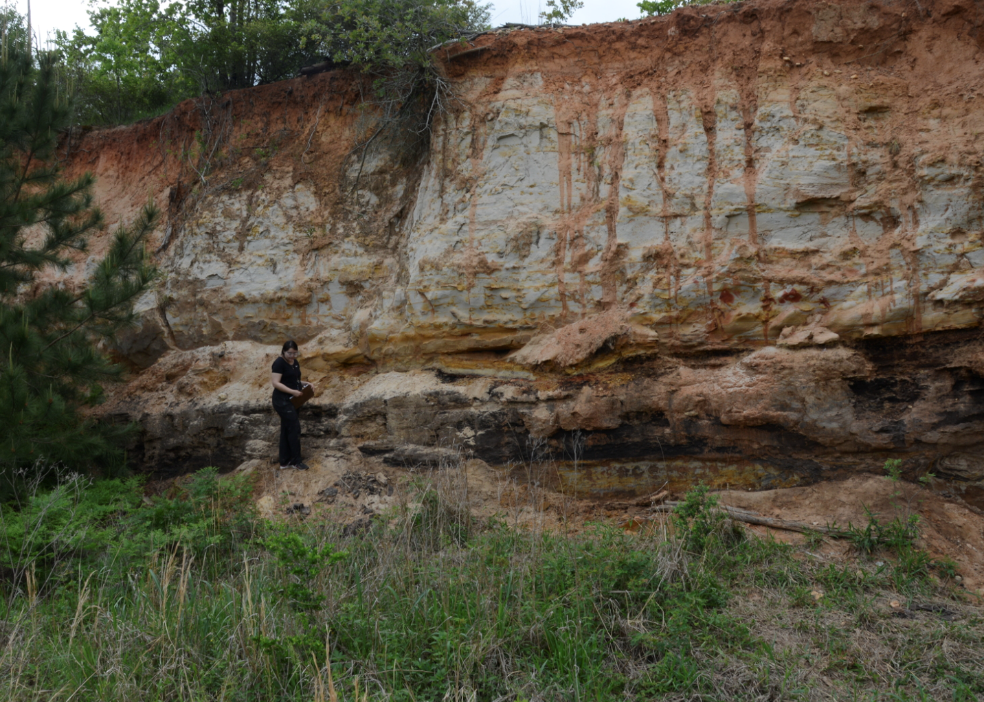 The author, Katherine Garcia, in the field in front of some sedimentary outcrops